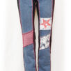 front view of washed out jeans with red star on the thigh