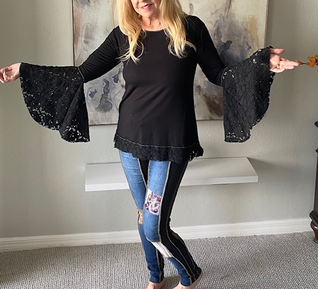 Model wearing black aline top with lace bell sleeves