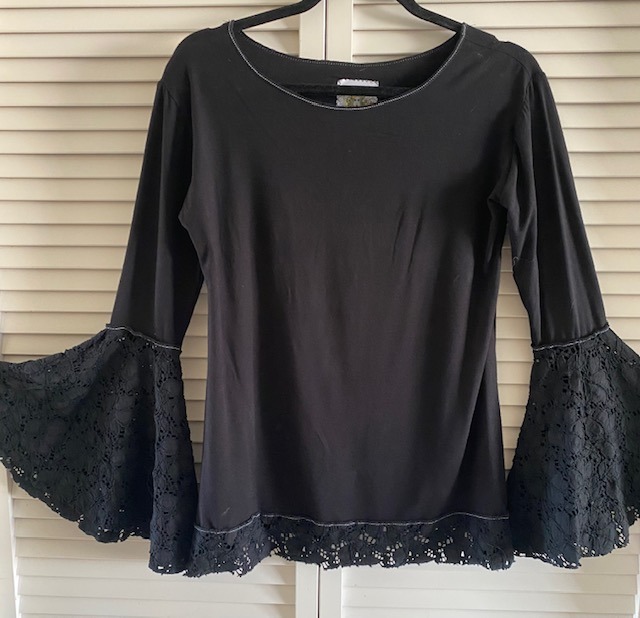 Black tunic top with bell sleeve in lace on hanger