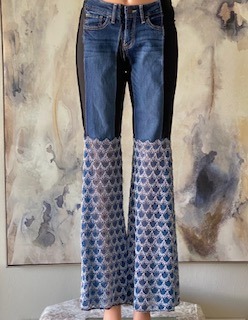 Mannequin wearing skinny jeans with black stretch sides and Blue deco style lace bell bottoms.
